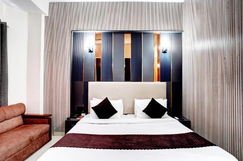 a hotel room with a bed and a couch at FabHotel Prime The Rivlet - MG Road & Sikanderpur Metro in Gurgaon