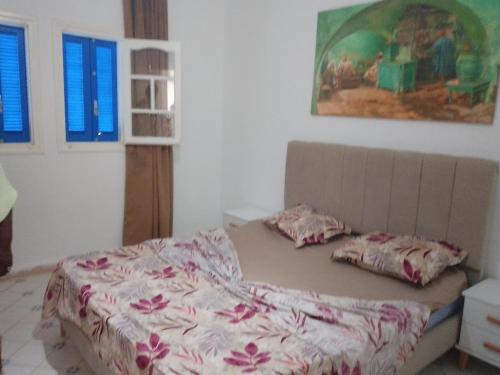 a bed with two pillows on it in a bedroom at Jamila 2 in Al Maqārisah