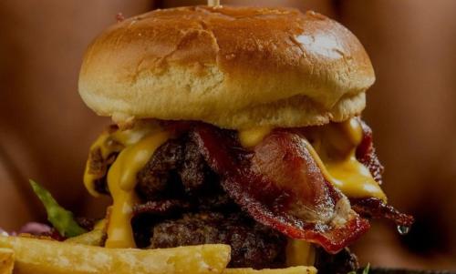 a sandwich with cheese and bacon and french fries at The Royal Oak in Hawkhurst