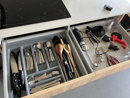 a drawer in a kitchen with utensils at Póvoa 3 suites in Póvoa de Varzim