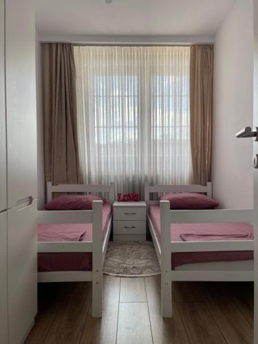 a bedroom with two bunk beds and a window at City View Prishtina in Pristina