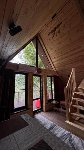 a room with a staircase in a wooden house at Green Hill Glamping in Almaty