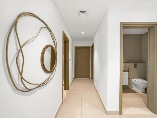 a hallway with a round mirror on a wall at Brand New! Downtown views located on Dubai Mall in Dubai