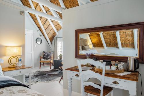 a bedroom with a desk with a mirror at 26 on Bree in McGregor