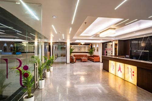 a lobby with potted plants in a building at Regenta Agra in Agra