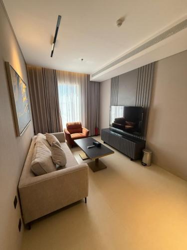 a living room with a couch and a table at ودق للشقق المخدومة in Riyadh
