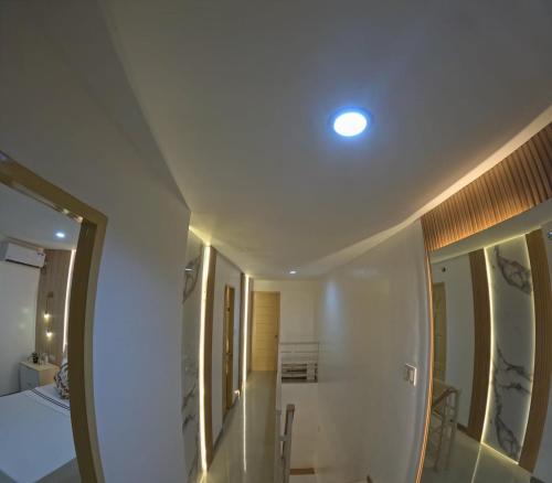 a white room with a bed and a mirror at Casa Maria-River view -2 storey house in Dauis