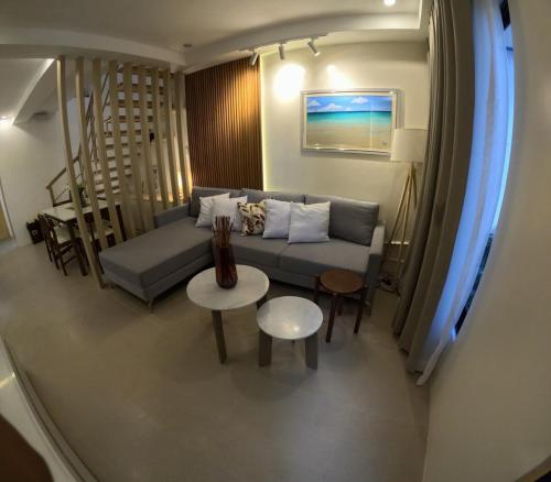 a living room with a couch and a table at Casa Maria-River view -2 storey house in Dauis