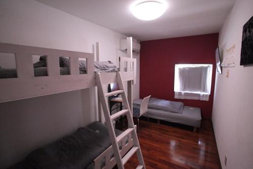 a room with two bunk beds and a window at M&Unity in Okinawa City
