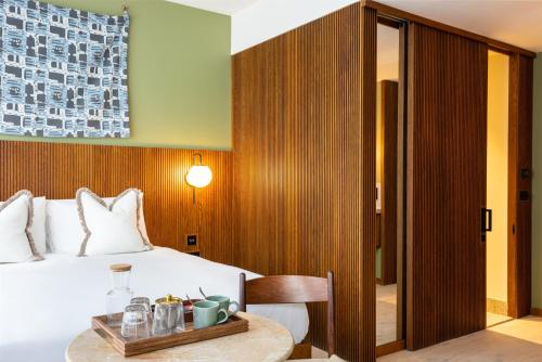 a hotel room with a bed and a table at Mollie's Manchester in Manchester