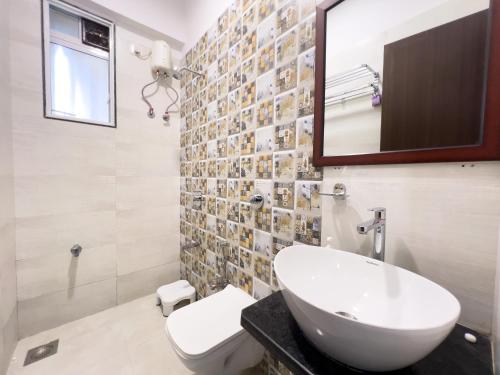 a bathroom with a sink and a mirror at Pinaki Comfort Stay Vile Parle - Near Airport in Mumbai