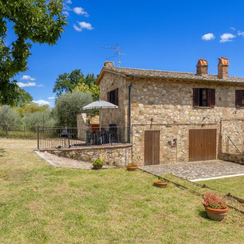 an external view of a stone house with a patio at Oliveto Del Cantarello in Chiusi