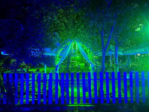 a playground with a slide behind a fence at night at Napoli Nataxtari hotel,pool,bar,kamping in Natakhtari