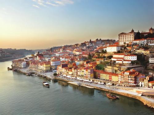 an aerial view of a city with boats in the water at Porto Surf Lodge in Porto