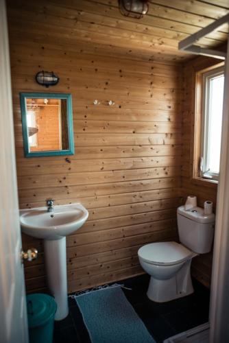 a bathroom with a white toilet and a sink at Da Silva Surfcamp in Areia Branca