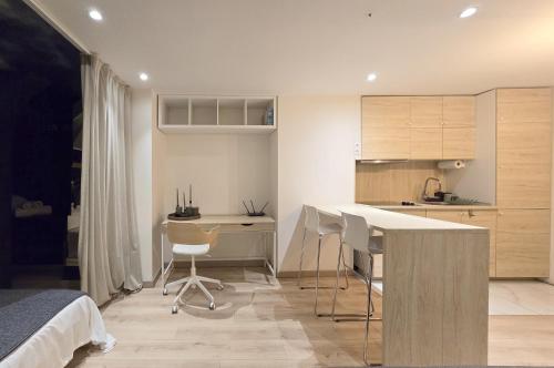 a kitchen with a table and chairs in a room at Mons Hypercentre in Mons