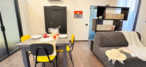 a living room with a table and a couch at Tema apartment by Ca-Sa Check in Chioggia