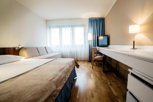 a hotel room with two beds and a sink at Omega Hotel in Olsztyn