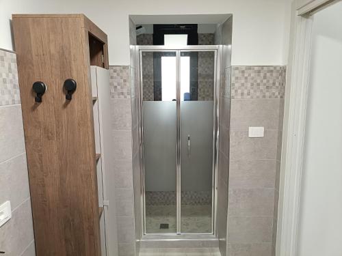 a shower with a glass door in a bathroom at Giordano Bruno 8 in Brindisi