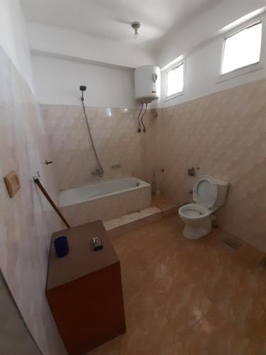 a bathroom with a tub and a toilet and a sink at Blue Sky Apartments & Restaurant in Luxor