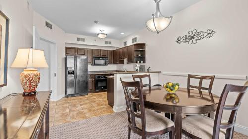 a kitchen and dining room with a table and chairs at Avila Serenity Suites - For 6 in Lake Ozark