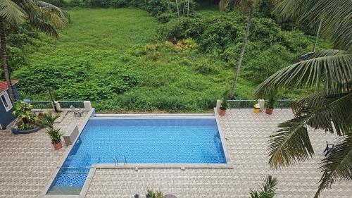 an overhead view of a swimming pool in a backyard at Beach Bliss Apartment Hotel - 7 Minutes walk to Beach in Colva