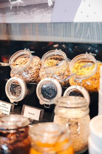 a display of jars filled with different types of food at Hotel MDM City Centre in Warsaw