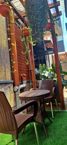 a patio with a table and chairs on the grass at Oreville Apartments in Goma