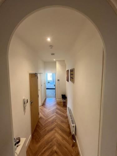 an empty hallway with an archway in a house at Seaside 3bed 6person Apartment - Perfect Getaway Retreat in Bexhill