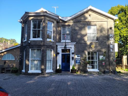an old brick building with a blue door at Nysdill Accommodation Ltd in Norwich