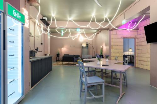a dining room with a table and chairs in a room at UrbanKey Studio Hostel - Vienna Landstrasse in Vienna