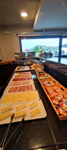 a buffet line with many different types of food at Hotel Apartamentos San Fermín Pamplona in Pamplona