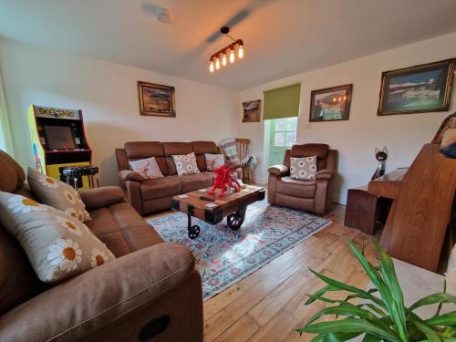 a living room with couches and a coffee table at Pen y Fan Cottage Log Burner Brecon Beacons with Breath taking views in Pont Sticill