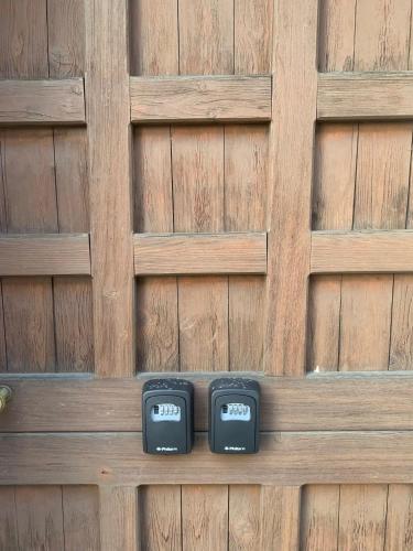 two clocks sitting on a wooden fence at 4 tea 4 house in Romano Canavese