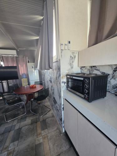 a kitchen with a small table and a microwave at Costas Court in Limassol