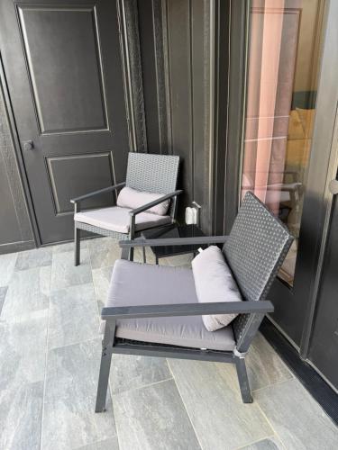 a couple of chairs sitting on a porch at 2 Bd - Bourbon Lovers Dream - Clemson & Greenville in Easley
