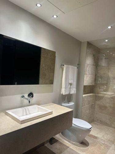 a bathroom with a sink and a toilet and a shower at Paramount Bay - Spectacular Ocean View in Puerto Vallarta
