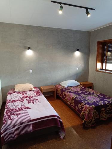 a bedroom with two beds and a window at SOBREIRO - Sobreiro Alojamento - Grijó in Grijó