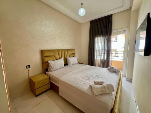 a bedroom with a bed and a window at Luxury Apartment - Fes Medina in Fès