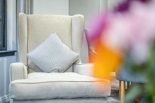 a pillow sitting on a chair in a room at Super Prime Abbey Free Parking By Tba in Dunfermline