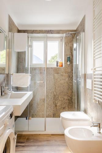 un bagno con wc, lavandino e doccia di Chalet Moderno Aprica - vicino alle piste e parcheggio incluso ad Aprica