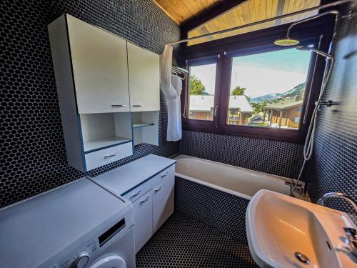a bathroom with a sink and a window at L'Envol de Praz - Proche pistes et base de loisirs in Praz-sur-Arly