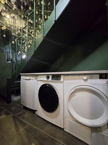 a washing machine in a room with a staircase at Mons Hypercentre in Mons