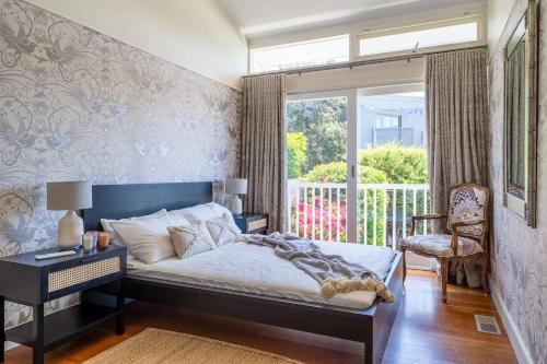 a bedroom with a bed and a window at The Bungan - Beachfront W Access To Bungan Beach in Newport