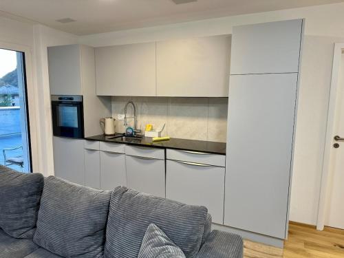 a living room with a couch and a kitchen at Haus Römerhof Apt 3 in Brig