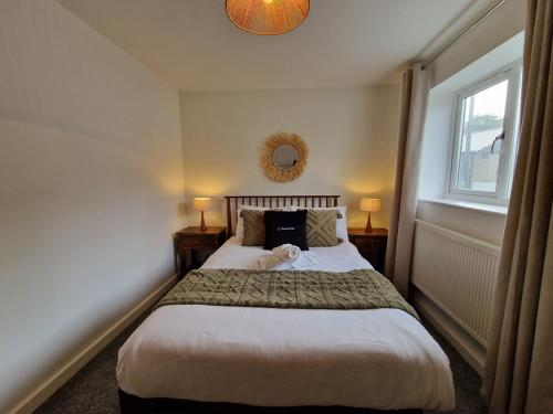a bedroom with a bed with a teddy bear on it at Chic 2 Bedroom Close to Town with Free Parking in Tredegar