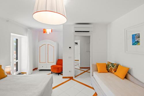 a white living room with a couch and a chair at Torre Paradiso in Minori