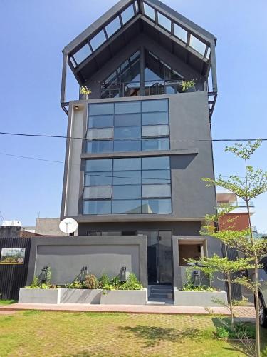 a tall building with glass windows on top of it at BuSoBlack in Maputo