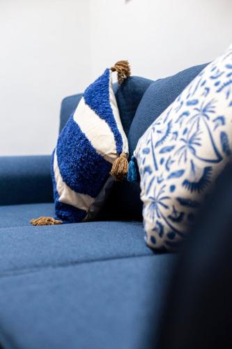 a blue and white couch with two pillows on it at Gueliz Gem Chic, Comfy & Central in Marrakech