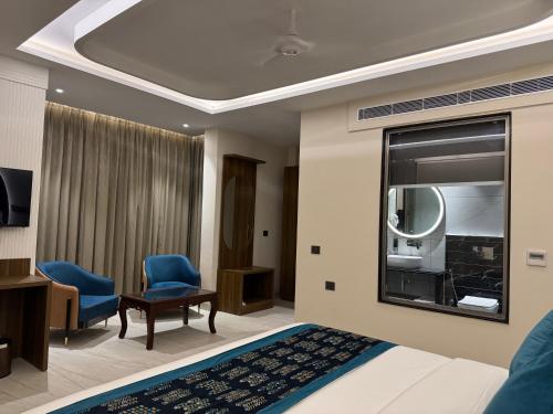 a hotel room with a bed and a mirror at RC Dream Palace in Greater Noida